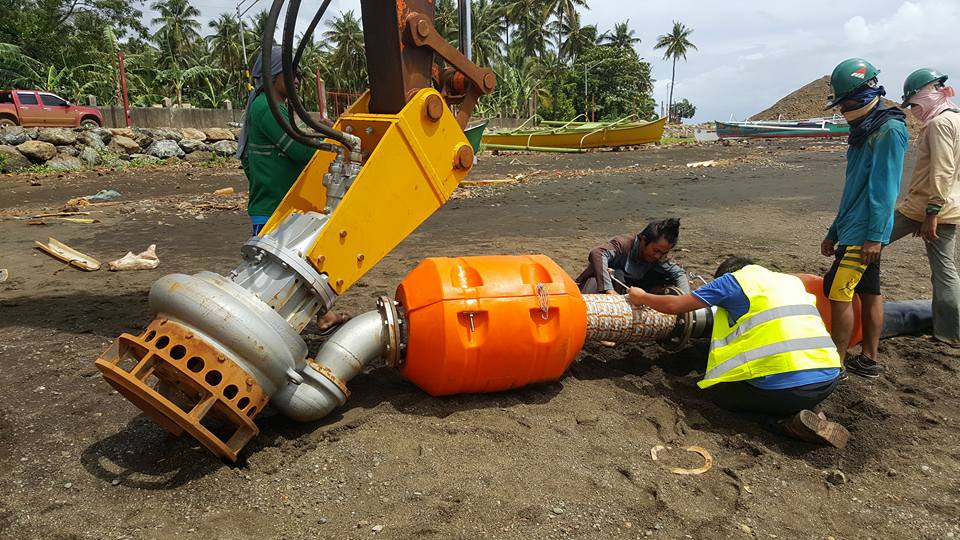 Dredging to remove silt and sediments from water for environmental protection