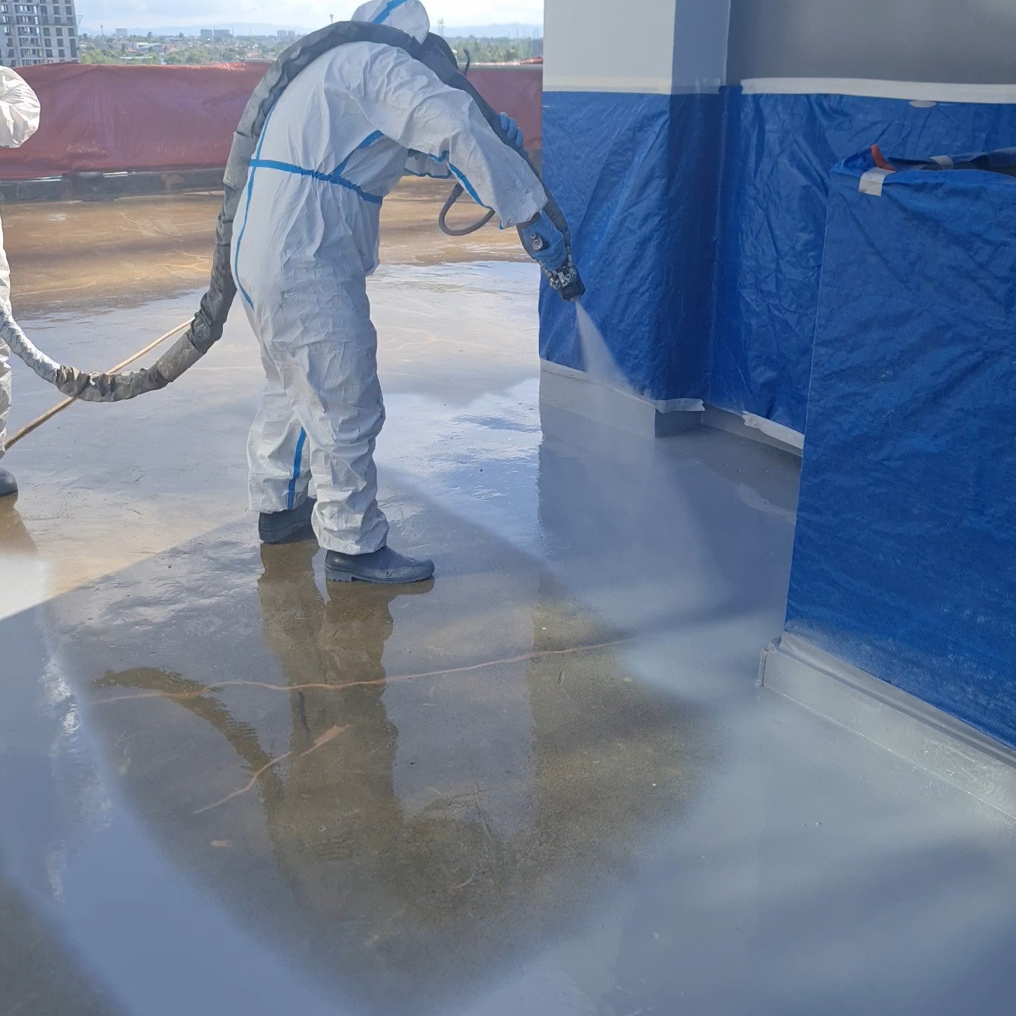 Applying polyurea advanced waterproofing on a roofdeck to prevent water leaks
